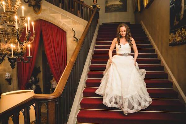 Bride Walking Down Castle Staircase