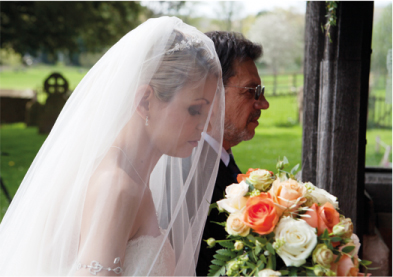 Bride and father walk into Eastnor Church