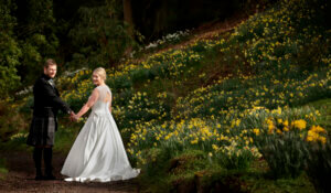 Couple on Upper Terrace  with daffodils behind them.